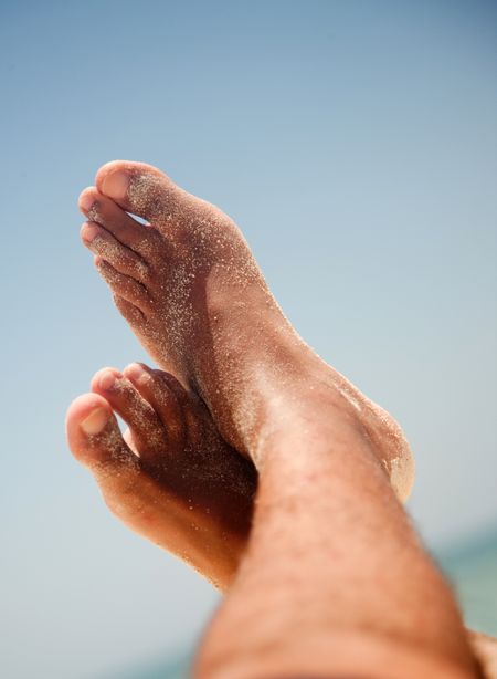 Image of sandy feet at the beach
