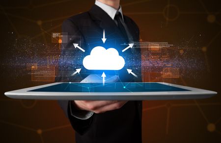 Businessman holding tablet with cloud concept
