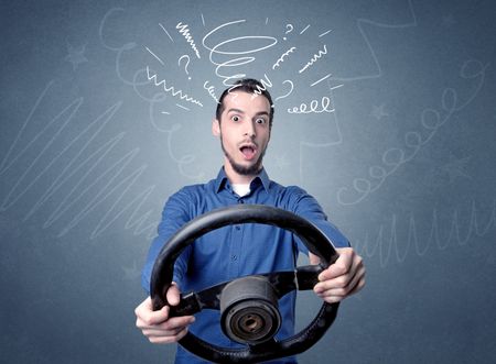 Young man holding black steering wheel with white scribbles around him