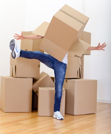 Woman playing with a cardboard box while packing