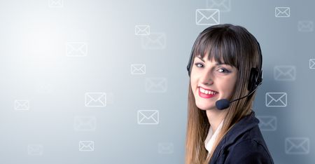Young female telemarketer with white envelopes surrounding her 