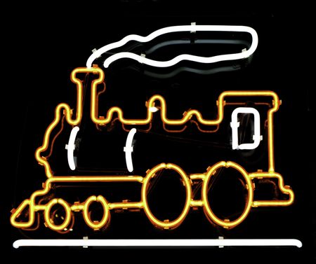 Neon sign of old-fashioned steam-powered locomotive and smoke in store window