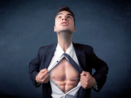 Businessman tearing off his shirt and showing mucular body concept on background