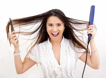 Woman with a hair straightener - isolated over a white background