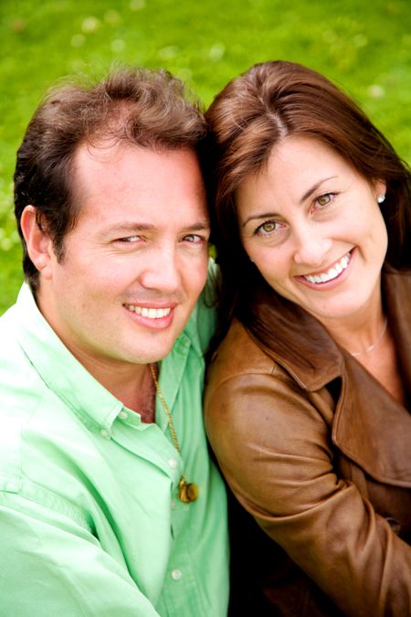 outdoors couple portrait where they are both smiling and looking very happy