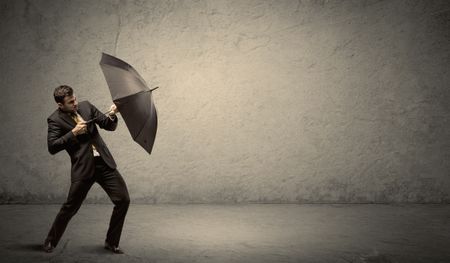 Handsome business man holding umbrella with copy space background concept