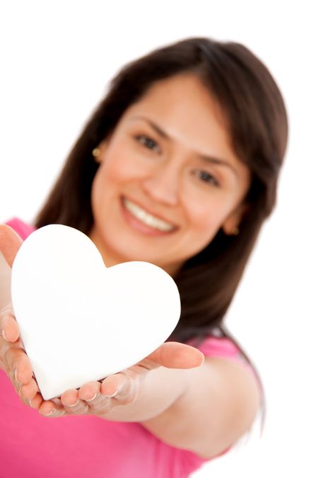 Woman holding a heart shaped object - isolated over white