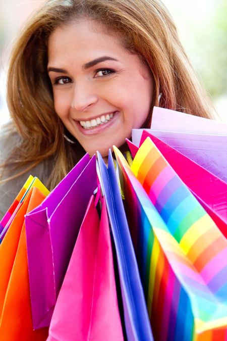 Happy shopping woman with bags and smiling
