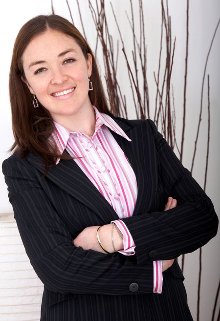 Business woman portrait smiling in an office - caucasian