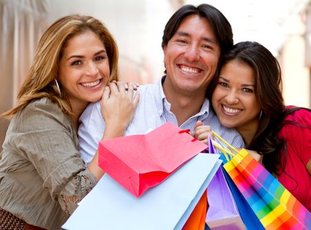 Group of happy shopping people with bags and smiling