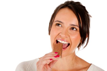 Woman eating a chocolate bar - isolated over white