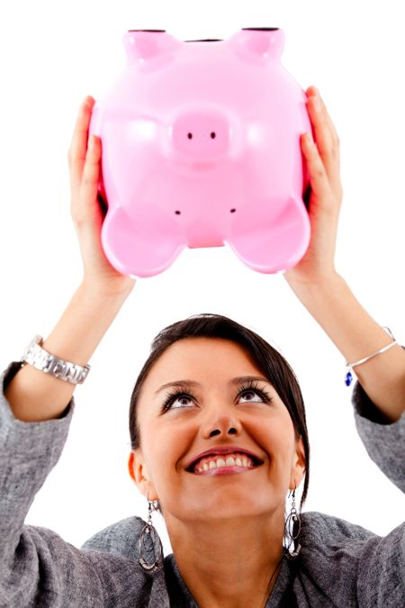Happy woman with her savings in a piggy bank - isolated