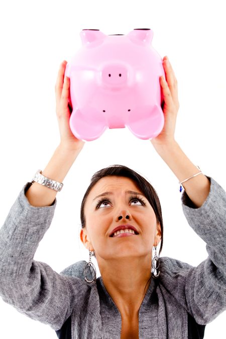 Desperate woman trying to take money out of a piggybank - isolated