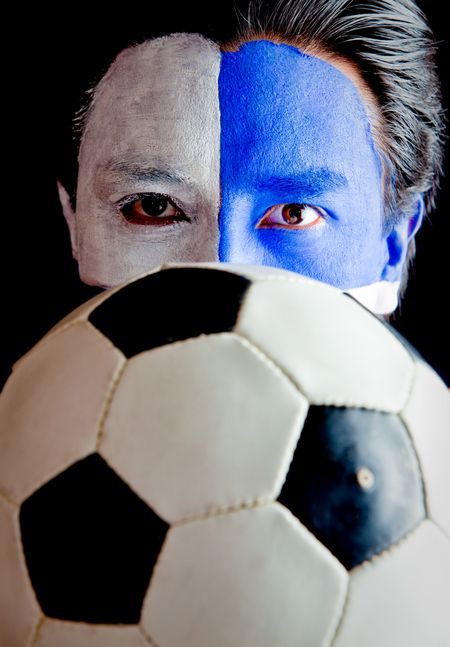Football fan with a blue and white flag painted on his face