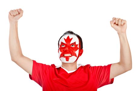 Happy Canadian man with the flag painted on his face and arms up- isolated