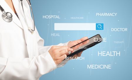 Female doctor holding tablet with blue background and search bar with hovering medical words