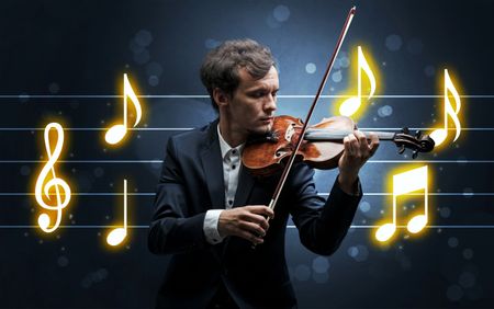 Young handsome fiddler playing with music sheet background