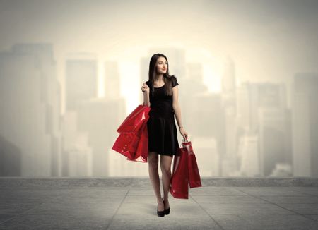 A stylish female standing with red shopping bags on platform and city view landscape backround concept
