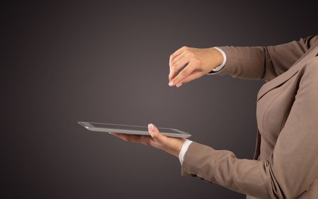 Female hand in suit holding tablet with no wallpaper
