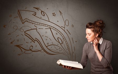 Casual young woman holding book with brown arrows and stars flying out of it