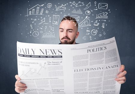 Young smart businessman reading daily newspaper with business plan graphics above his head