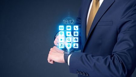 Businessman wearing smartwatch with application icons.