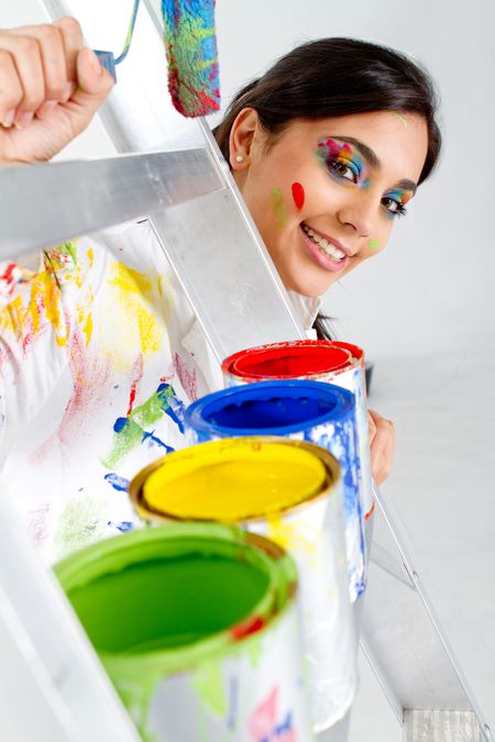 Female painter with paint cans in different colors