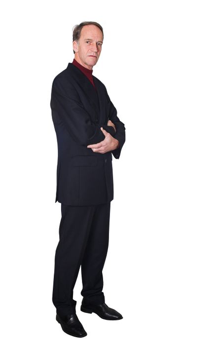 confident business man standing with his arms crossed