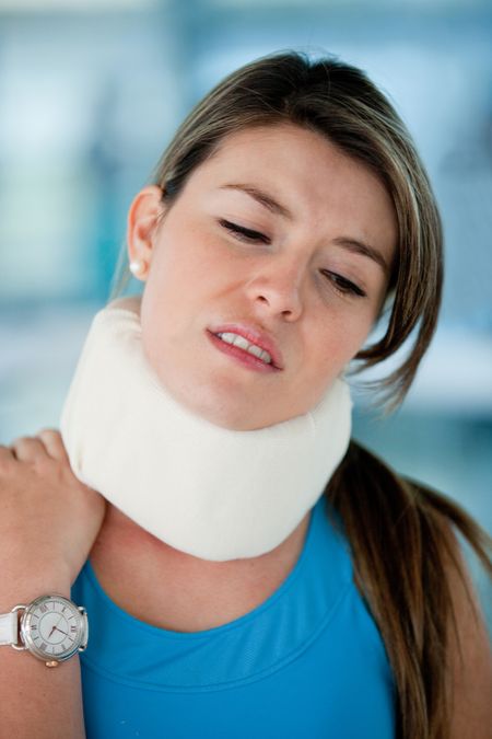 Athletic young woman in pain with a surgical collar
