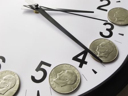 Concept of time is money: Eisenhower dollar coins on face of analog clock