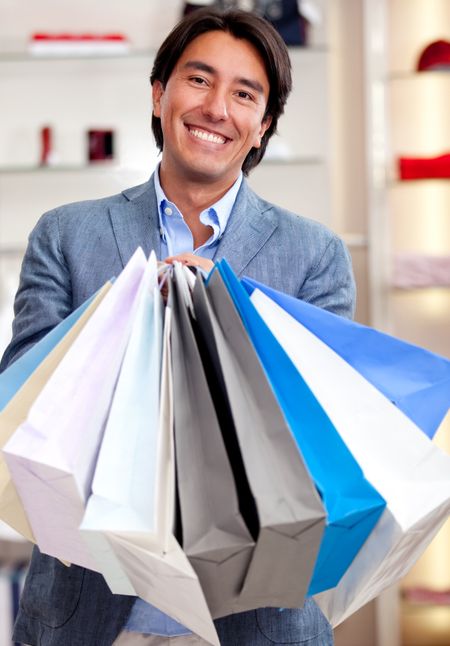 Man holding shopping bags at a retail store