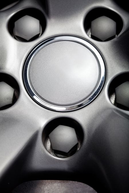 Picture of a black car tire with focus on the rim