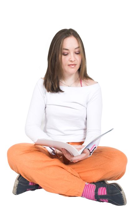 beautiful girl reading on the floor over a white background
