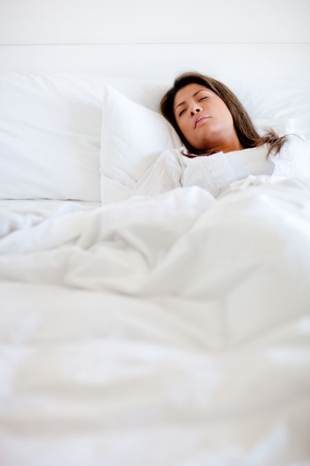 Woman sleeping in bed looking very comfortable