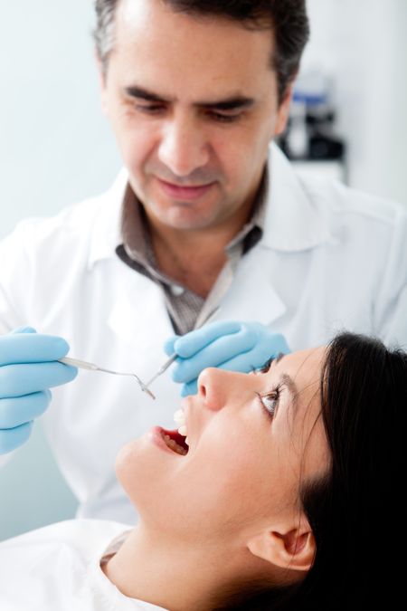Woman visiting the dentist for cleaning and checkup