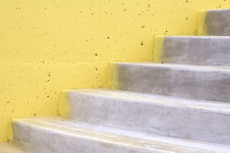 Abutment of concrete steps with pockmarked yellow wall in a marina in the Florida panhandle