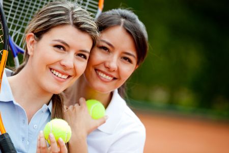 Beautiful women at the tennis court ready to play