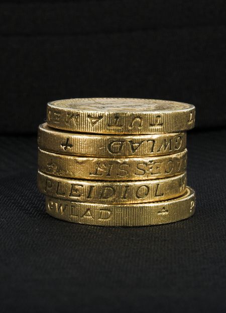 british coins over a black background