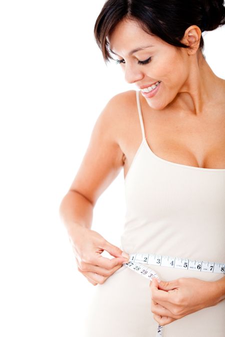 Woman measuring her waist trying to lose weight - isolated over white