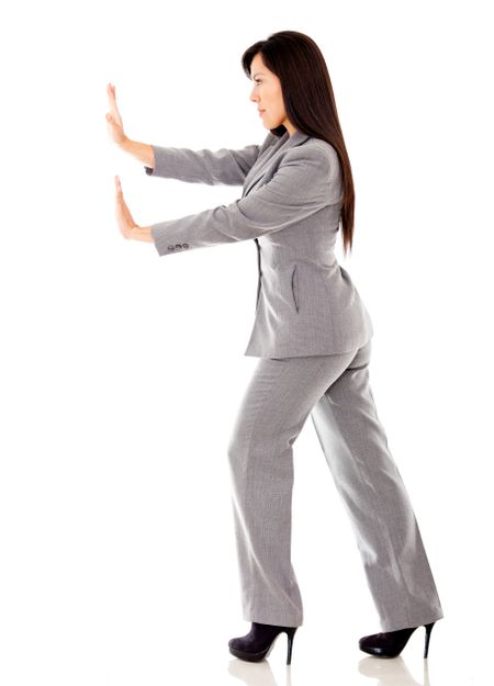 Business woman pushing an imaginary object - isolated over white