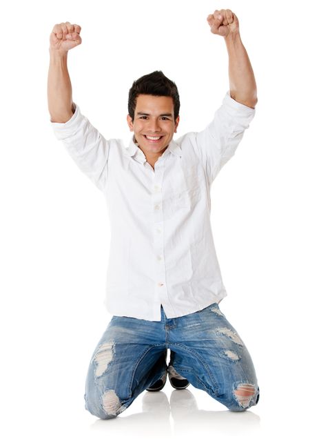 Happy man with arms up and smiling - isolated over a white background