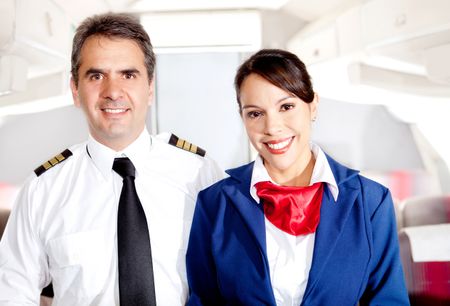Airplane cabin crew with pilot and flight attendant smiling