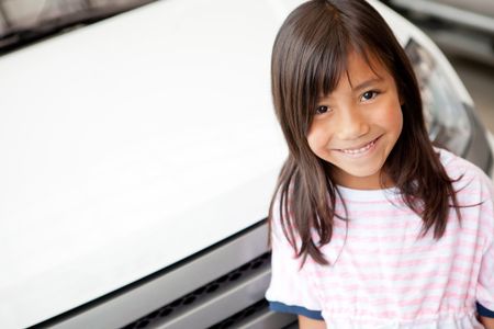 Happy girl at a car dealer smiling