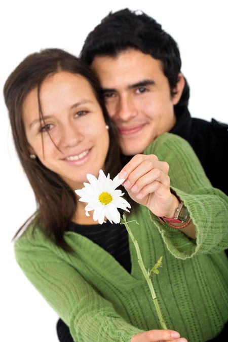 happy couple of young adults with a flower smiling - isolated over a white background