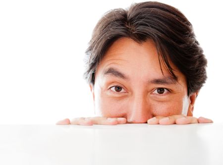 Man peeking over a table - isolated over a white background